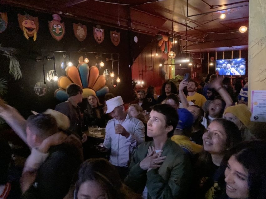 People watch the game in a bar.
