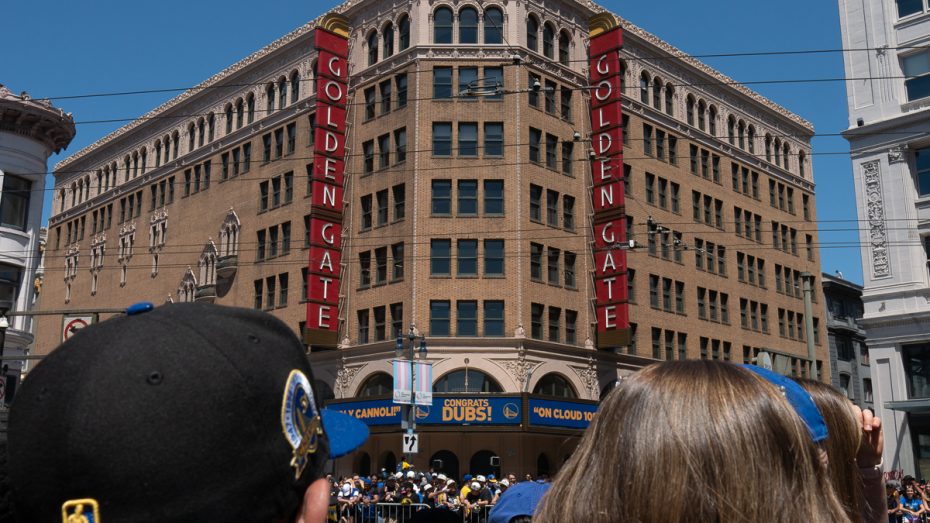 Two fans look at a sign that reads "Congrats Dubs!"