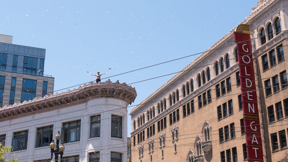 Warriors fan waves flags on top of apartment building