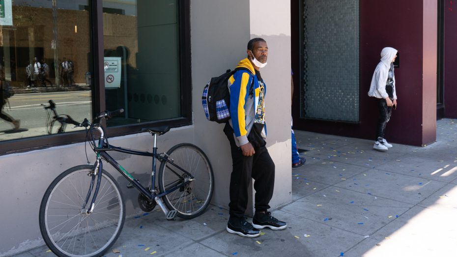 A Warriors fan waits for the bus.