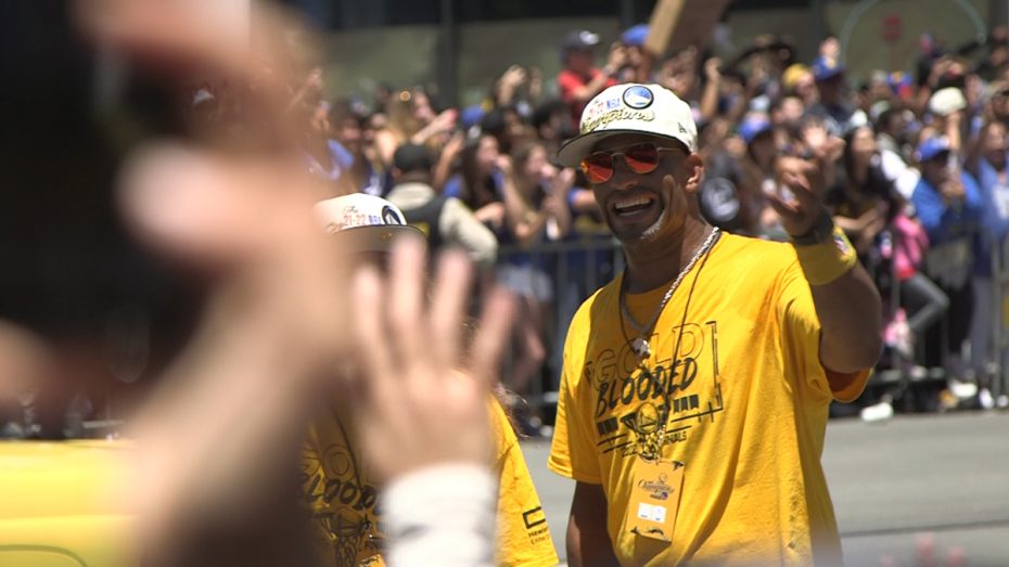 Warriors "Team Members" wave at the crowd.