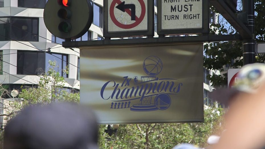 A sign hangs on a light post that reads, "7x Champions"
