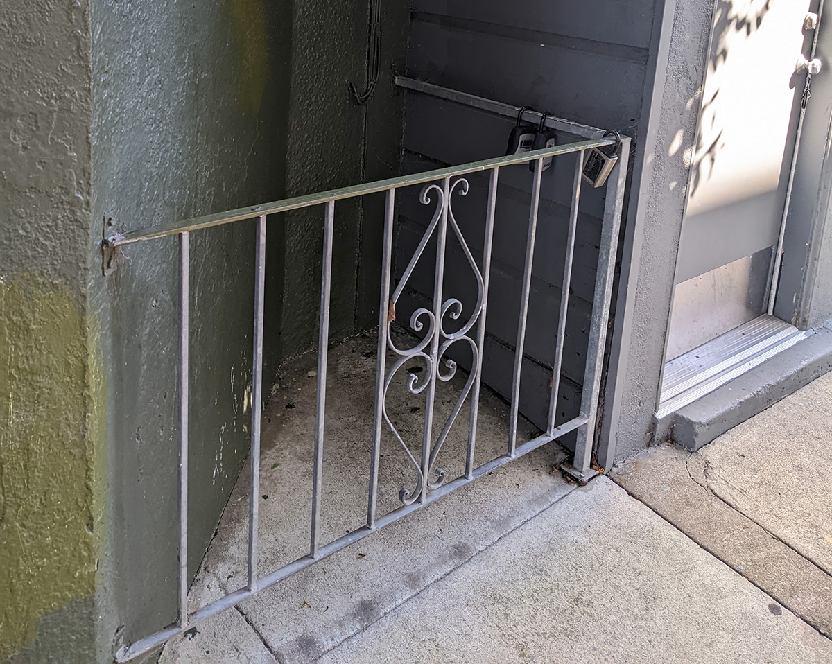 An outdoor gate at the corner of a building