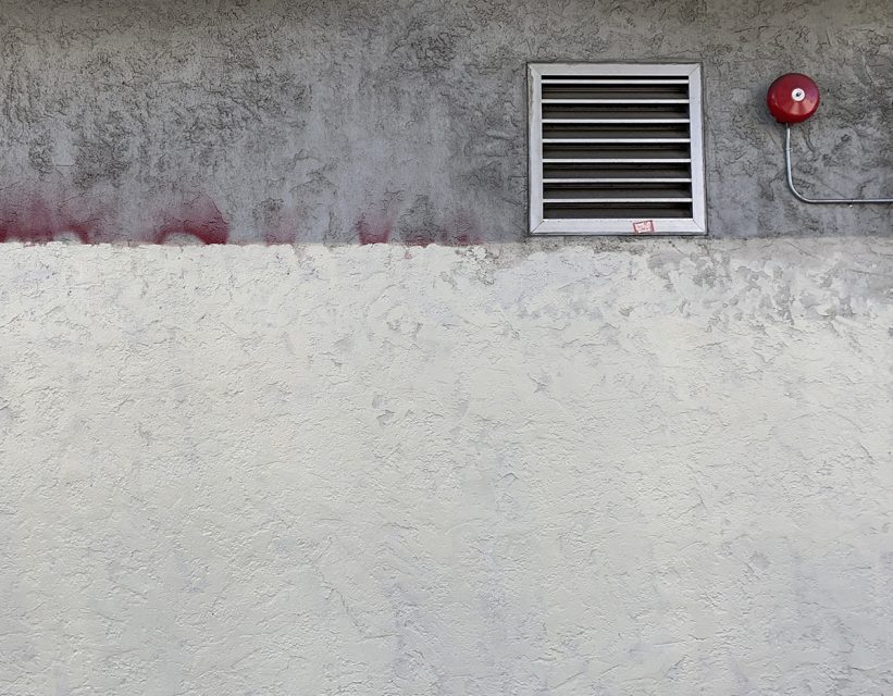 The edge of a building that meets the siidewalk