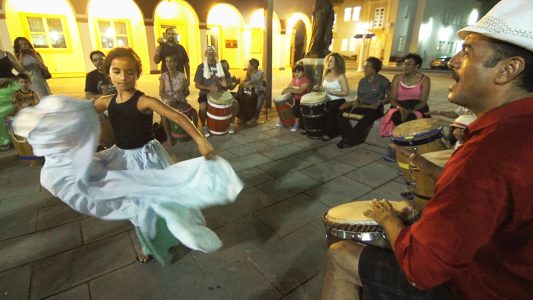 A girl dancing and a drummer