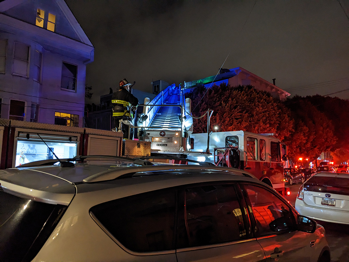 A fireman looking on from the truck.