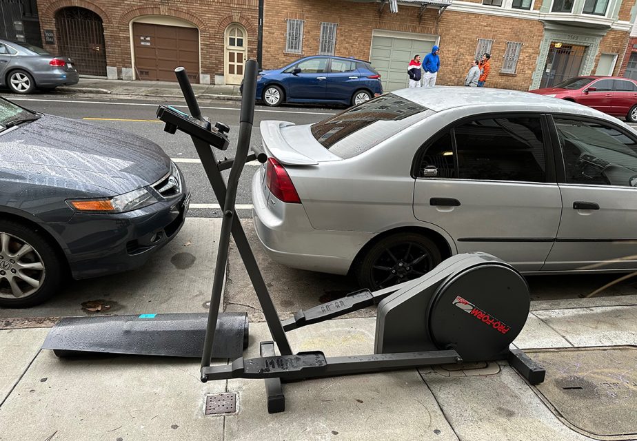An exercise machine on the sidewalk.