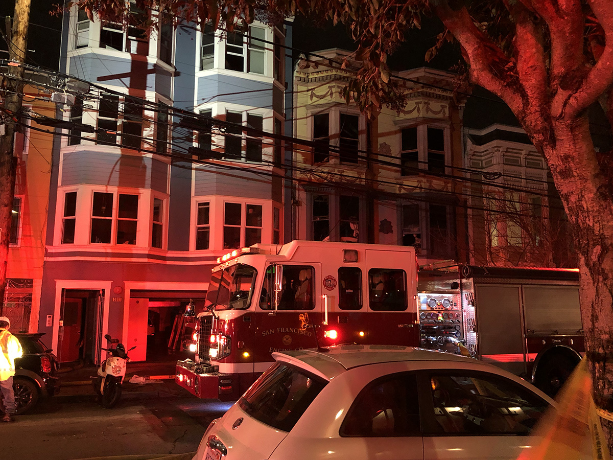 A fire engine at night in front of a building