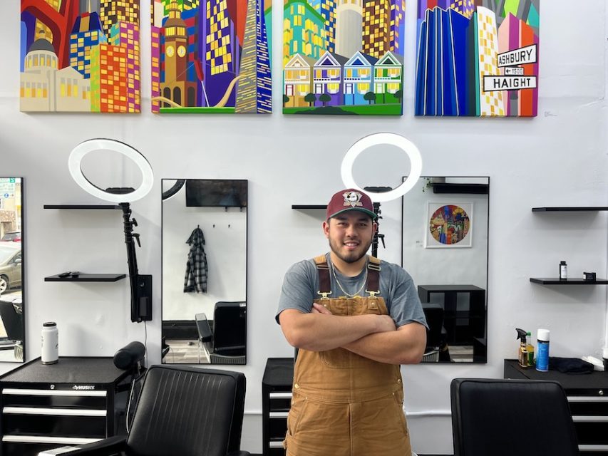 Barber in barbershop with paintings