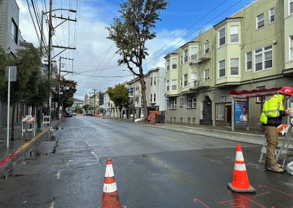 A street blocked with traffic cones.