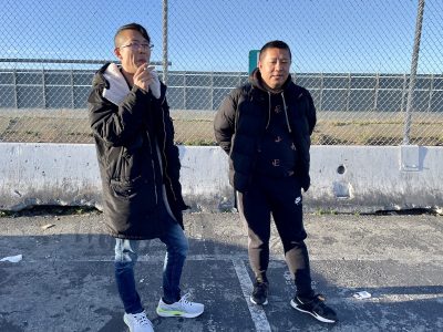 Two people standing and smoking