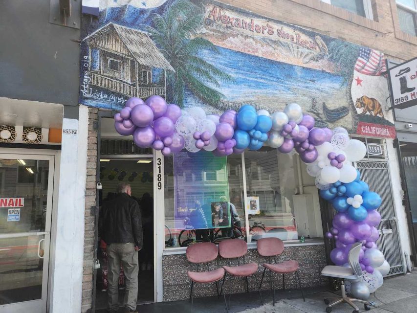 A storefront with balloons.