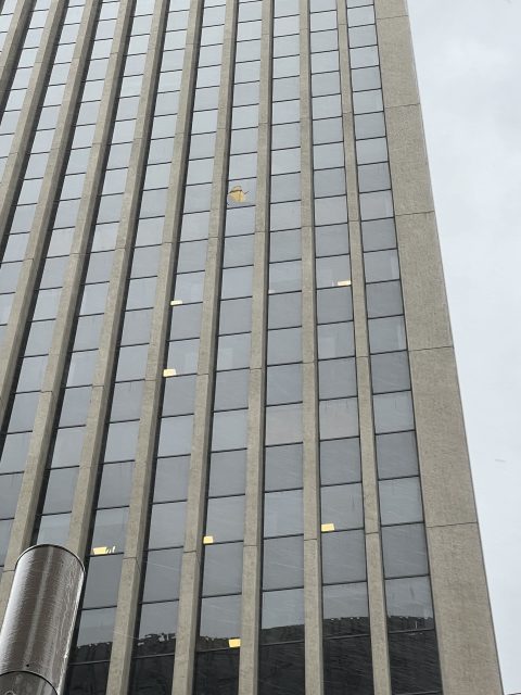 Broken window at 50 California.