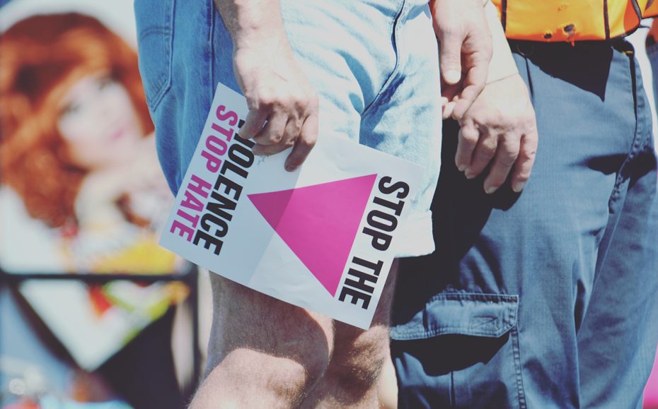 People with a stop the violence, stop poster.