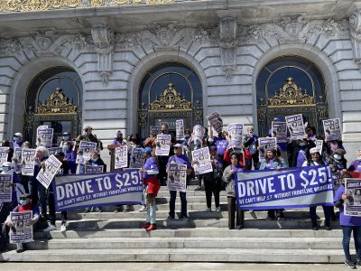 A group of people holding posters.
