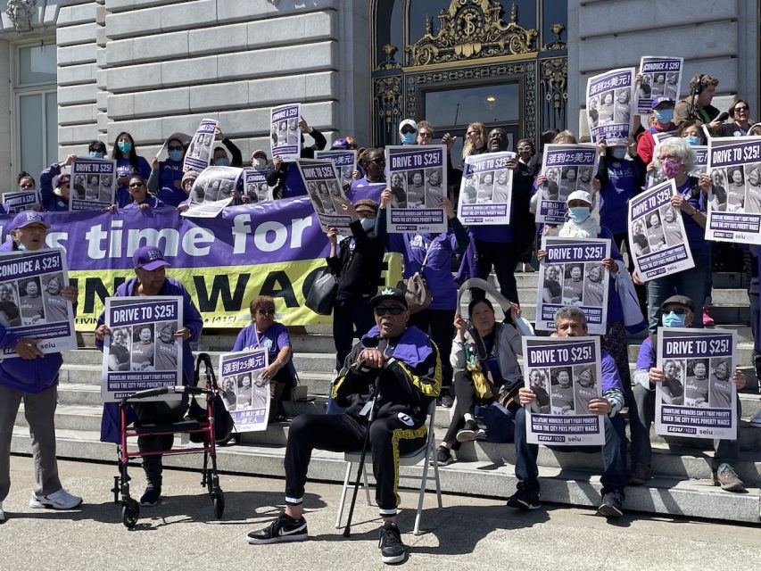A group of people holding posters.