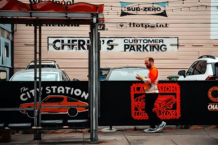 Man walking looking t his hand.