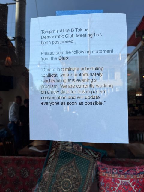 Sign reading "Tonight's Alice B Toklas Democratic Club Meeting has been postponed. Please see the following statement from the Club: "Due to last minute scheduling conflicts, we are unfortunately rescheduling this evening's program. We are currently working on a new date for this important conversation and will update everyone as soon as possible."