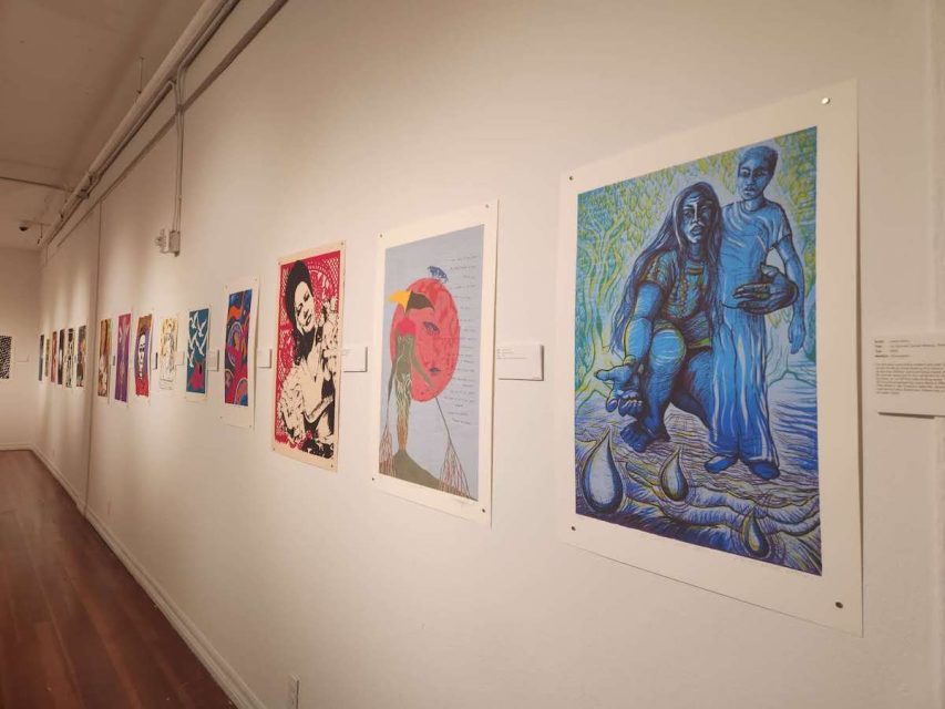 posters on a wall of a gallery