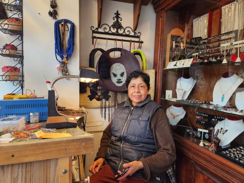 a woman sitting in her chair beside a shelf