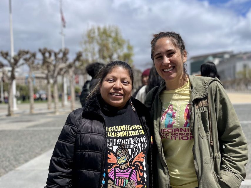 Two people smiling and standing on International Workers’ Day