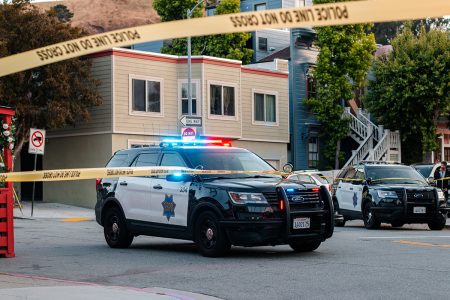 A police car and police line yellow tape.