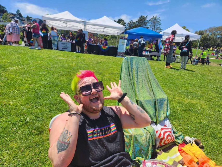 A person with neon color hair before the Trans March