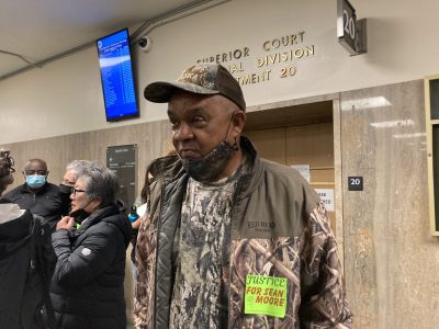 Man standing in the hall in front of court room