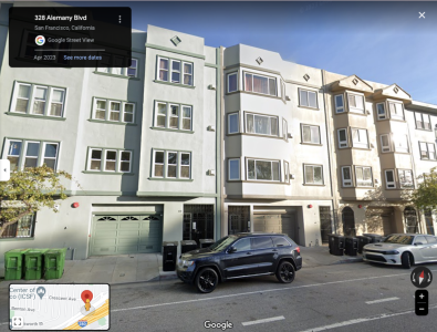 Four rectangular residential buildings on a street.