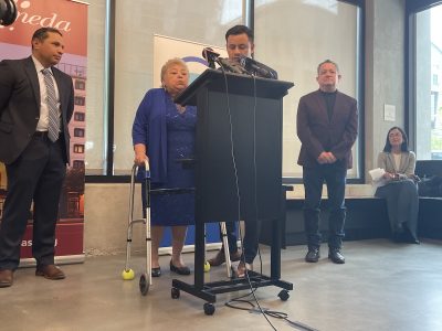 Speakers at a new affordable housing press conference at the podium.