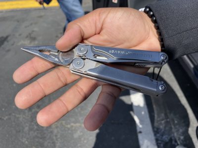A hand holding a pair of pliers