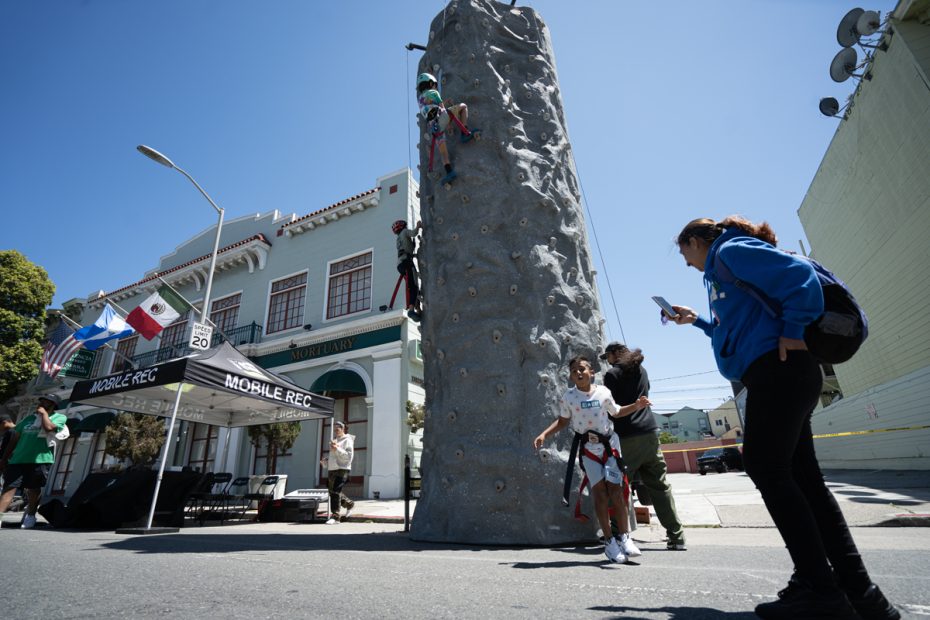 Rock climbing and someone helping a child. 