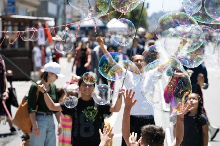 Loads of bubbles and people on the street.