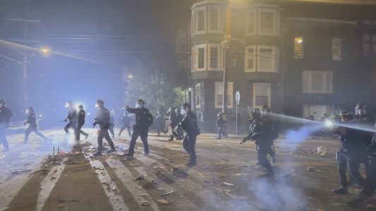police officers running and shining flashlights