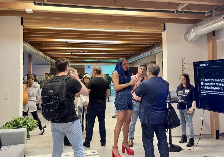 A group of people talking to each other indoors