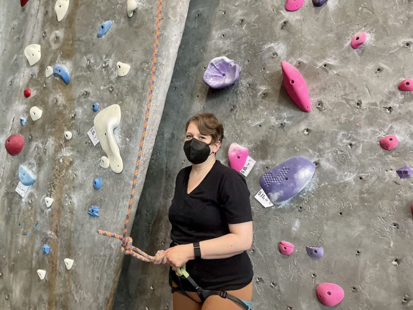 A person standing in front of a wall