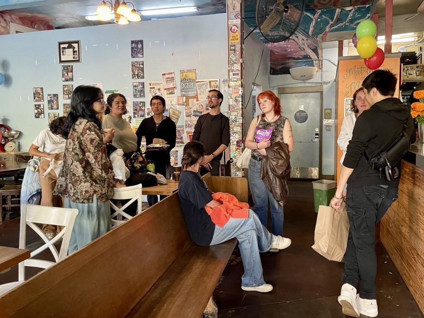 A group of people standing around in a at Philz.