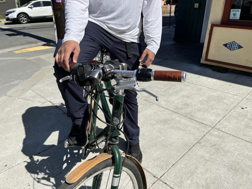 A man sitting on a bike.