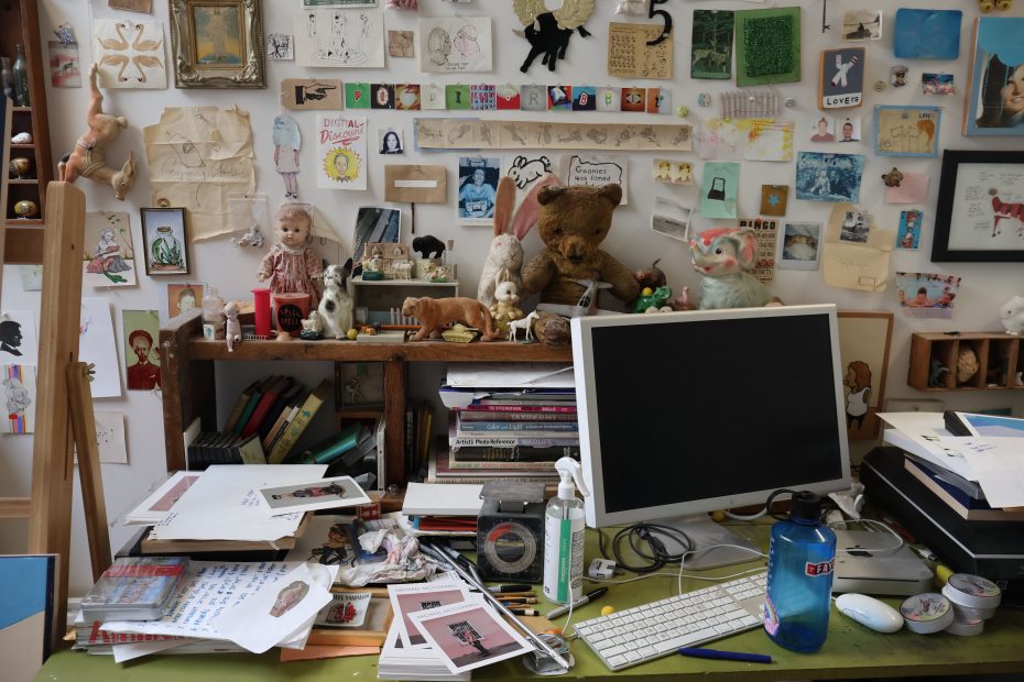 A desk with a teddy bear on it.