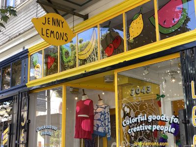 a yellow storefront with a lemon-shaped sign reading Jenny Lemons
