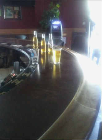 Clooney's Pub with several bottles of beer on it.