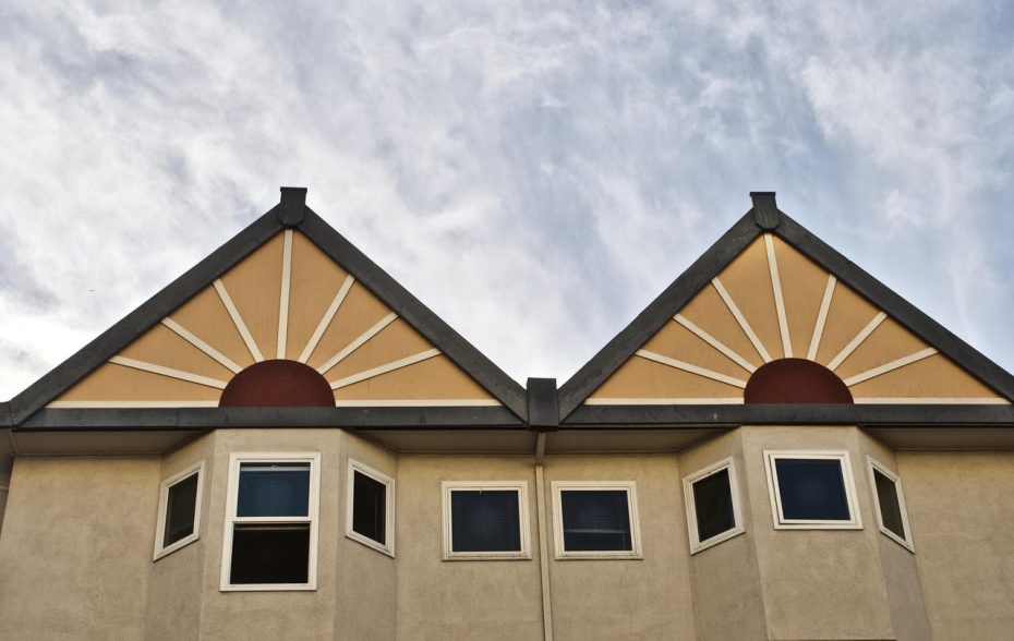 two roof gables with the patterns of sunset on them.