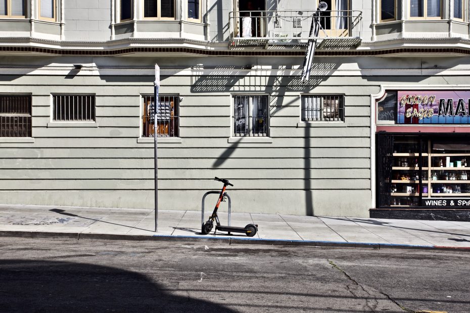 A scooter is parked in front of a building.