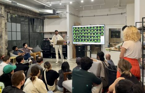 A group of people observing an AI-related presentation in a room during the AI boom.