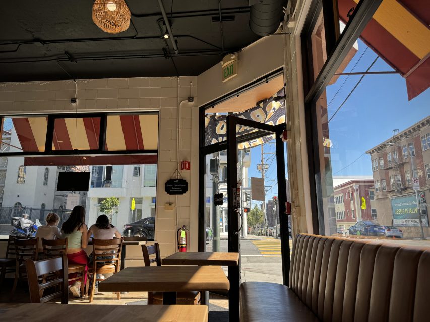 The inside of Carlin's cafe with large windows and abundant natural light