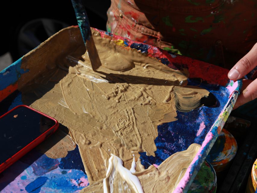 A person holding a paint brush.