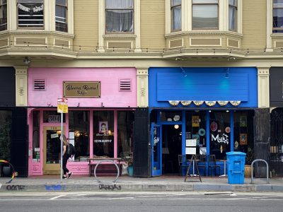 Two storefronts on Valencia street, one painted in pint and one painted in blue