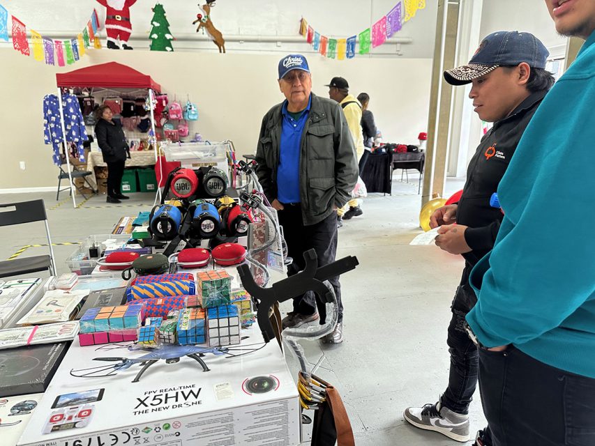 A group of people standing around a table.
