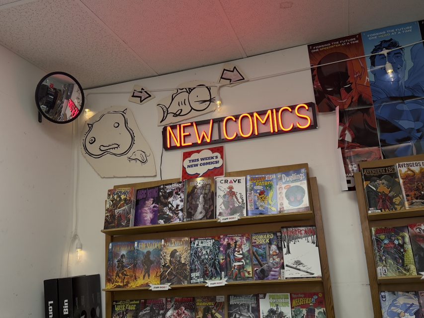A comic book store with a sign that says new comics.