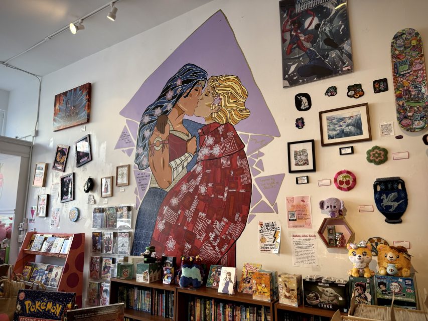 A comic book store with a lot of art on the wall.